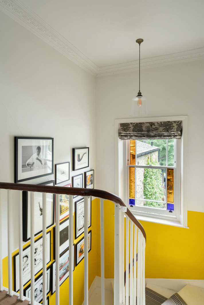 gallery wall and color block technique add depth in this staircase