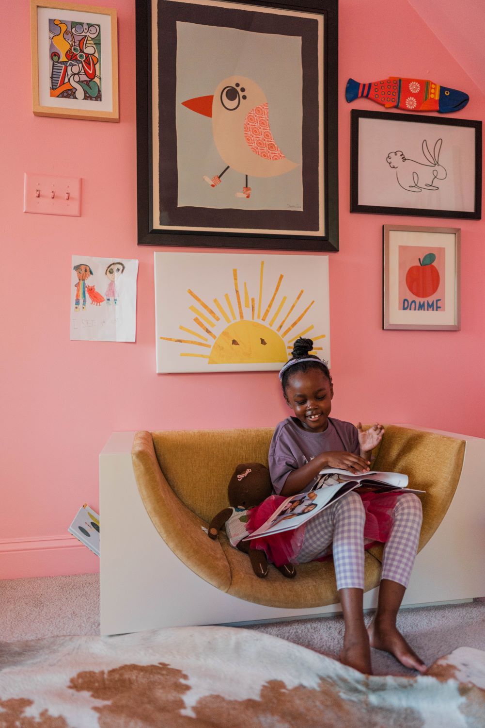 gallery wall in kid's room with modern bookshelf & seating