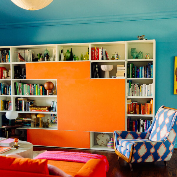 Italian bookcase and vintage pieces in color drenched living room