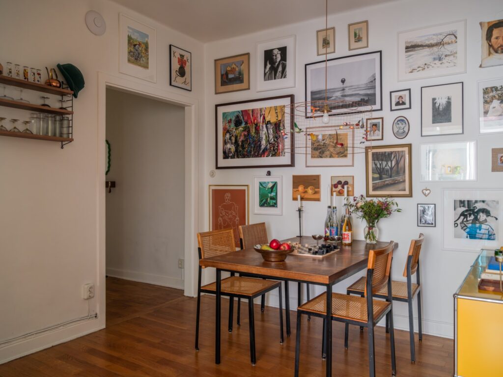 vintage dining table and chairs with gallery wall in dining nook