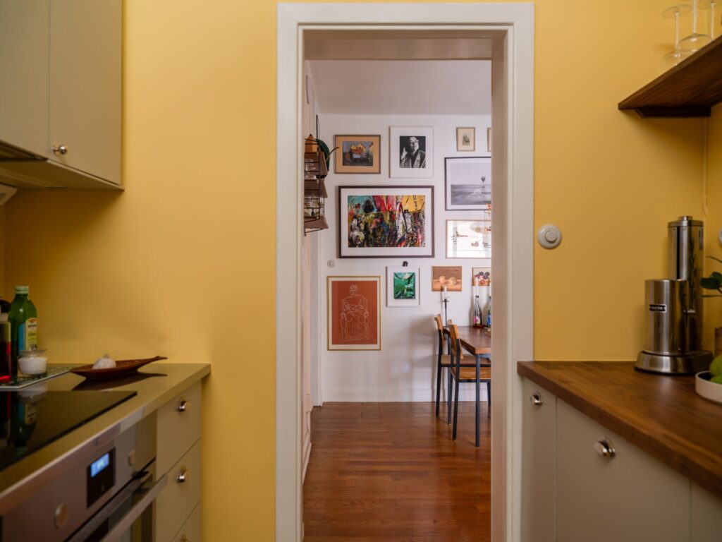 yellow kitchen with peek into dining nook